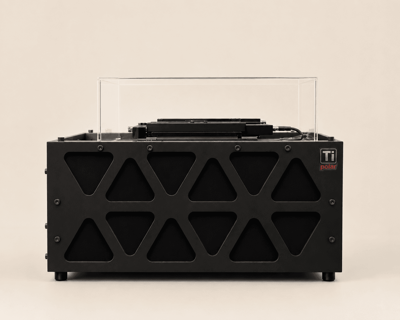 TiPolar instrument, head-on: a black chassis with a triangular-cutout front grille and a clear acrylic lid over the stage.